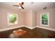 Comfortable bedroom features hardwood floors, two windows and a ceiling fan at 3002 Laguna Dr, Decatur, GA 30032