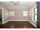 A spacious bedroom with a ceiling fan, hardwood floors, and two windows at 3002 Laguna Dr, Decatur, GA 30032