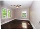 Bright bedroom with hardwood floors, ceiling fan, and lots of natural light from the many windows at 3002 Laguna Dr, Decatur, GA 30032