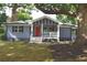 Charming single-story home features a welcoming front porch, a red front door and gray brick at 3002 Laguna Dr, Decatur, GA 30032