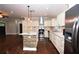 Well-lit kitchen boasts stainless appliances, stone island, and custom white cabinets at 3002 Laguna Dr, Decatur, GA 30032