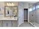 Elegant bathroom with double vanity, large mirror, and walk-in shower at 606 Broadview Ne Ter, Atlanta, GA 30324