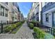 Brick-paved walkway through a townhome community with manicured landscaping at 606 Broadview Ne Ter, Atlanta, GA 30324