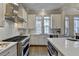 Kitchen with white cabinets, stainless steel appliances, and subway tile at 606 Broadview Ne Ter, Atlanta, GA 30324