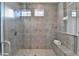 Spacious walk-in shower with gray tile and built-in seat at 606 Broadview Ne Ter, Atlanta, GA 30324