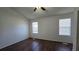 Bright bedroom with dark brown wood-look flooring and ceiling fan at 6628 Wellington Sq, Norcross, GA 30093