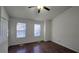 Bright bedroom with dark brown wood-look flooring and ceiling fan at 6628 Wellington Sq, Norcross, GA 30093