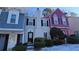 Three townhouses in a row with varying colors, including blue, beige, and pink at 6628 Wellington Sq, Norcross, GA 30093