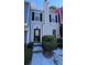 Beige townhouse with a light-colored front door and landscaping at 6628 Wellington Sq, Norcross, GA 30093