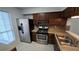 Clean kitchen with stainless steel appliances and wood cabinets at 6628 Wellington Sq, Norcross, GA 30093