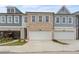 Three-unit townhouse building with gray and brick facade at 1032 Rose Dr, Marietta, GA 30060
