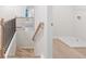 Elegant staircase with a black railing and light wood steps at 1032 Rose Dr, Marietta, GA 30060