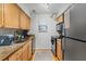 Galley kitchen with granite counters and stainless steel appliances at 1150 Collier Nw Rd # J15, Atlanta, GA 30318