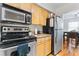 Modern kitchen with stainless steel appliances and light wood cabinets at 1150 Collier Nw Rd # J15, Atlanta, GA 30318
