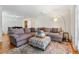 Bright living room with sectional sofa, ottoman, and hardwood floors at 1150 Collier Nw Rd # J15, Atlanta, GA 30318