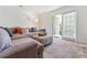 Spacious living room with sectional sofa and balcony access at 1150 Collier Nw Rd # J15, Atlanta, GA 30318