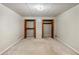 Spacious basement bedroom with two closets and carpeted floor at 157 Timberlost Trl, Suwanee, GA 30024