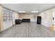 Spacious basement rec room with grey laminate floors and neutral walls at 157 Timberlost Trl, Suwanee, GA 30024