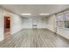 Finished basement room with built-in shelving and laminate flooring at 157 Timberlost Trl, Suwanee, GA 30024