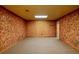 Spacious basement room with wood paneling and carpeted floor at 157 Timberlost Trl, Suwanee, GA 30024