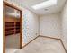 Small basement room with built-in shelving and patterned wallpaper at 157 Timberlost Trl, Suwanee, GA 30024