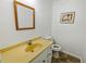 Small bathroom with yellow vanity and tiled floor at 157 Timberlost Trl, Suwanee, GA 30024