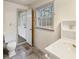 Main floor bathroom with toilet, sink and grey tile floor at 157 Timberlost Trl, Suwanee, GA 30024