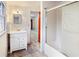 Basement bathroom with tub, shower, and white vanity at 157 Timberlost Trl, Suwanee, GA 30024