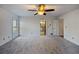 Spacious bedroom with ceiling fan and access to bathroom at 157 Timberlost Trl, Suwanee, GA 30024