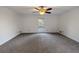 Large bedroom with ceiling fan and window at 157 Timberlost Trl, Suwanee, GA 30024