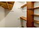 Walk-in closet with wooden shelving and hanging rods at 157 Timberlost Trl, Suwanee, GA 30024