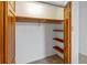 Bedroom closet with wood shelving and hanging rod at 157 Timberlost Trl, Suwanee, GA 30024