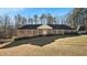 Brick ranch home with a large yard and mature trees at 157 Timberlost Trl, Suwanee, GA 30024