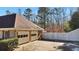 Two-car garage with brick exterior and white fence at 157 Timberlost Trl, Suwanee, GA 30024