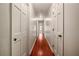 Long hallway with hardwood floors and neutral walls at 157 Timberlost Trl, Suwanee, GA 30024