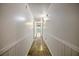 Long hallway with tiled floor and white wainscoting at 157 Timberlost Trl, Suwanee, GA 30024