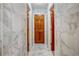 Long hallway with marble tile and access to bedrooms at 157 Timberlost Trl, Suwanee, GA 30024