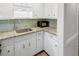 Kitchen corner with granite countertops and white cabinets at 157 Timberlost Trl, Suwanee, GA 30024