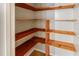 Walk-in pantry with ample wooden shelving at 157 Timberlost Trl, Suwanee, GA 30024