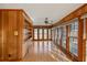 Sunroom features wood paneling, built-in shelving, and hardwood floors at 157 Timberlost Trl, Suwanee, GA 30024