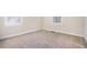 Simple bedroom with neutral carpeting and two windows at 2329 Abner Nw Pl, Atlanta, GA 30318