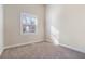 Well-lit bedroom featuring a large window and neutral carpeting at 2329 Abner Nw Pl, Atlanta, GA 30318