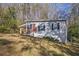 Side view of a gray house with red door and landscaping at 2329 Abner Nw Pl, Atlanta, GA 30318