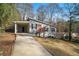 Gray house with red door, covered carport, and landscaped yard at 2329 Abner Nw Pl, Atlanta, GA 30318
