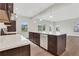 Spacious kitchen with island, white countertops, and dark brown cabinets at 1601 Fuma Leaf Way, Mcdonough, GA 30253