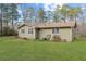 Spacious backyard with grassy area and air conditioning unit at 400 Fleeta Dr, Covington, GA 30016