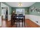 Bright dining room features hardwood floors and a view into the kitchen at 400 Fleeta Dr, Covington, GA 30016