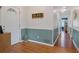 Bright entryway with wood floors, coat rack, and view to living room at 400 Fleeta Dr, Covington, GA 30016