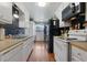 White kitchen with black appliances and wood flooring at 400 Fleeta Dr, Covington, GA 30016