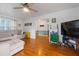 Cozy living room with hardwood floors and a sectional sofa at 400 Fleeta Dr, Covington, GA 30016